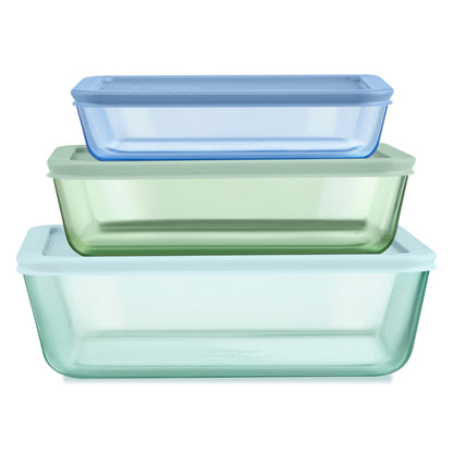 Set of three rectangular glass food containers with lids in blue, green, and clear on a white background.