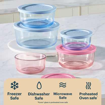 Set of glass food containers with lids on a white surface, featuring Pyrex branding.