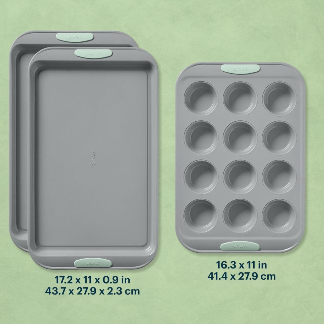 Set of three gray baking trays with measurements on a green background