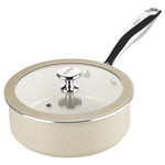 Cream-colored saucepan with glass lid and black handle on a white background