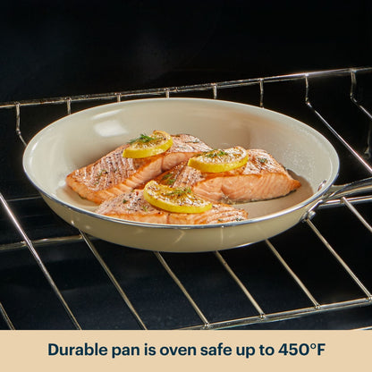 Salmon dish in a white pan with lemon slices on an oven rack, text indicating oven safety.