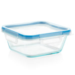 Clear glass food container with blue lid on a white background