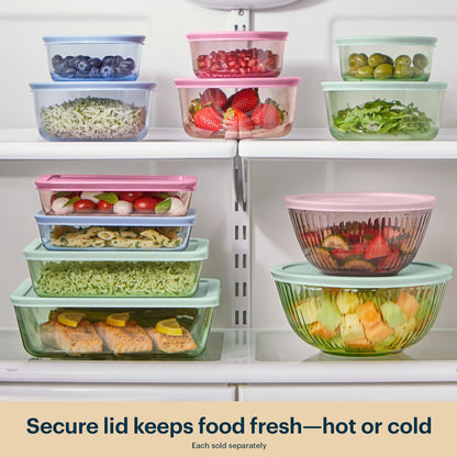 Colorful food storage containers with lids on a refrigerator shelf.