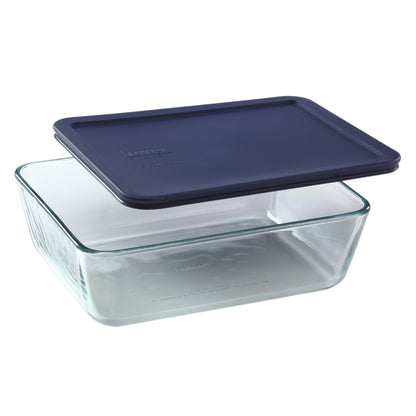 Clear glass food storage container with a navy blue lid on a white background