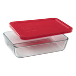 Clear glass food storage container with a red lid on a white background